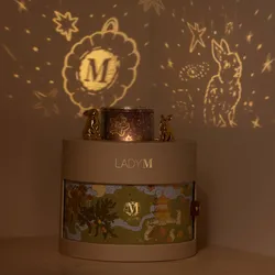Lady M gift box projecting mooncake and rabbit silhouette onto wall.