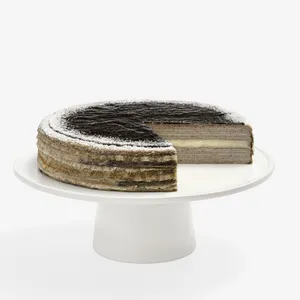 Whole Sesame Mochi Mille Crêpes cake on white stand, one slice removed showing mochi center layer