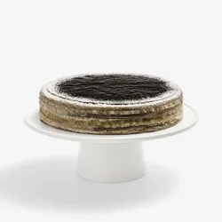 Whole Sesame Mochi Mille Crêpes cake on white stand, powdered sugar dusted top