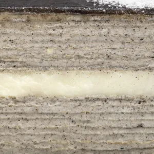 Close-up of Sesame Mochi Mille Crêpes layers and vanilla cream center band