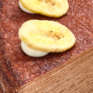 Close-up of banana chip and cream garnish on Chocolate Banana Mille Crêpes