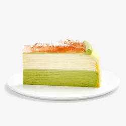 Single slice of Coconut Matcha Mille Crêpes topped with jam and shredded coconut