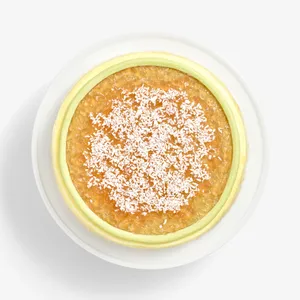Overhead view of Coconut Matcha Mille Crêpes topped with jam and shredded coconut