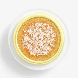 Overhead view of Coconut Matcha Mille Crêpes topped with jam and shredded coconut
