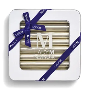 Lady M Coconut Crêpe Biscuit tin tied with a navy ribbon