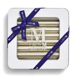 Lady M Coconut Crêpe Biscuit tin tied with a navy ribbon
