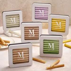 Six Lady M crêpe biscuit tins in all flavors with rolled biscuits displayed alongside