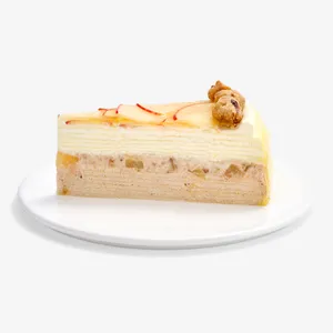 Slice of Apple Pie Mille Crêpes on a white plate, showing crêpe layers, diced apple, and crumble