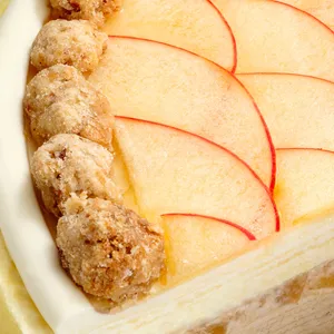 Close-up of apple slices and sugared crumble clusters atop Apple Pie Mille Crêpes