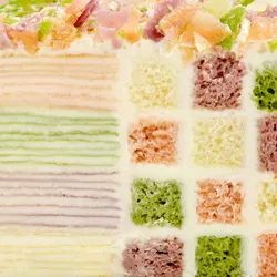 Close-up of Lady M Birthday Cake rainbow Mille Crêpe layers and checkerboard sponge