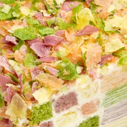 Close-up of colorful crêpefetti topping on the Lady M Birthday Cake