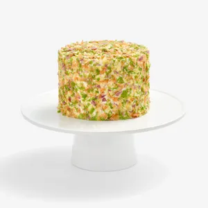 Whole Lady M Birthday Cake 6" covered in colorful crêpefetti on a white cake stand