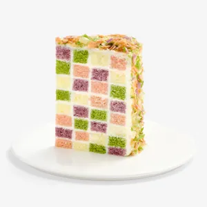 Slice of Lady M Birthday Cake 6" showing checkerboard sponge layered with birthday cake cream